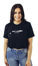 Load image into Gallery viewer, Women&#39;s Ain&#39;t Laurent cropped graphic tee. Paired with medium washed distressed skinny jeans. 
