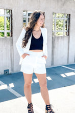 Load image into Gallery viewer, women&#39;s white blazer and short set paired with a black ribbed vneck tank top
