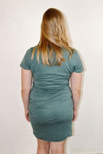 Load image into Gallery viewer, Back of women&#39;s green tshirt dress with tulip hem and ruched side

