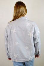 Load image into Gallery viewer, Back of women&#39;s oversized star print denim jacket. Paired with light wash high waisted ripped paperbag waist mom jeans. 
