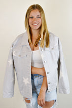 Load image into Gallery viewer, Women&#39;s oversized denim star jacket paired with a white ribbed crop tank top and light wash high waisted paperbag ripped mom jeans
