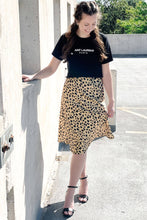 Load image into Gallery viewer, Women&#39;s Aint Laurent cropped graphic tee. Paired with a silky satin midi gold leopard skirt
