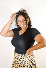 Load image into Gallery viewer, Women&#39;s black one piece bodysuit paired with women&#39;s satin gold leopard midi skirt with waistband 
