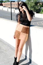 Load image into Gallery viewer, Brown suede skirt with color blocking on an aline mini skirt. Featuring a zip closure and small slit in the back. Paired with a black puff sleeve blouse
