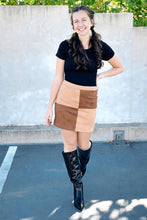 Load image into Gallery viewer, Brown suede skirt with color blocking pattern on the front. Back zip clousure. Paired with a black tshirt bodysuit and alligator knee high boots
