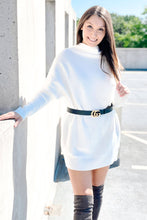 Load image into Gallery viewer, Women&#39;s oversized white long sleeve turtleneck sweater dress paired with a black Gucci belt and knee high suede boots. 
