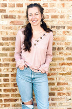 Load image into Gallery viewer, Women&#39;s blush waffle knit shirt with decorative buttons. Paired with light wash high waisted ripped boyfriend jeans. 
