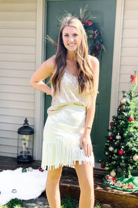 white denim fringe skirt with zipper paired with gold glitter sequin sparkle tank top with adjustable straps